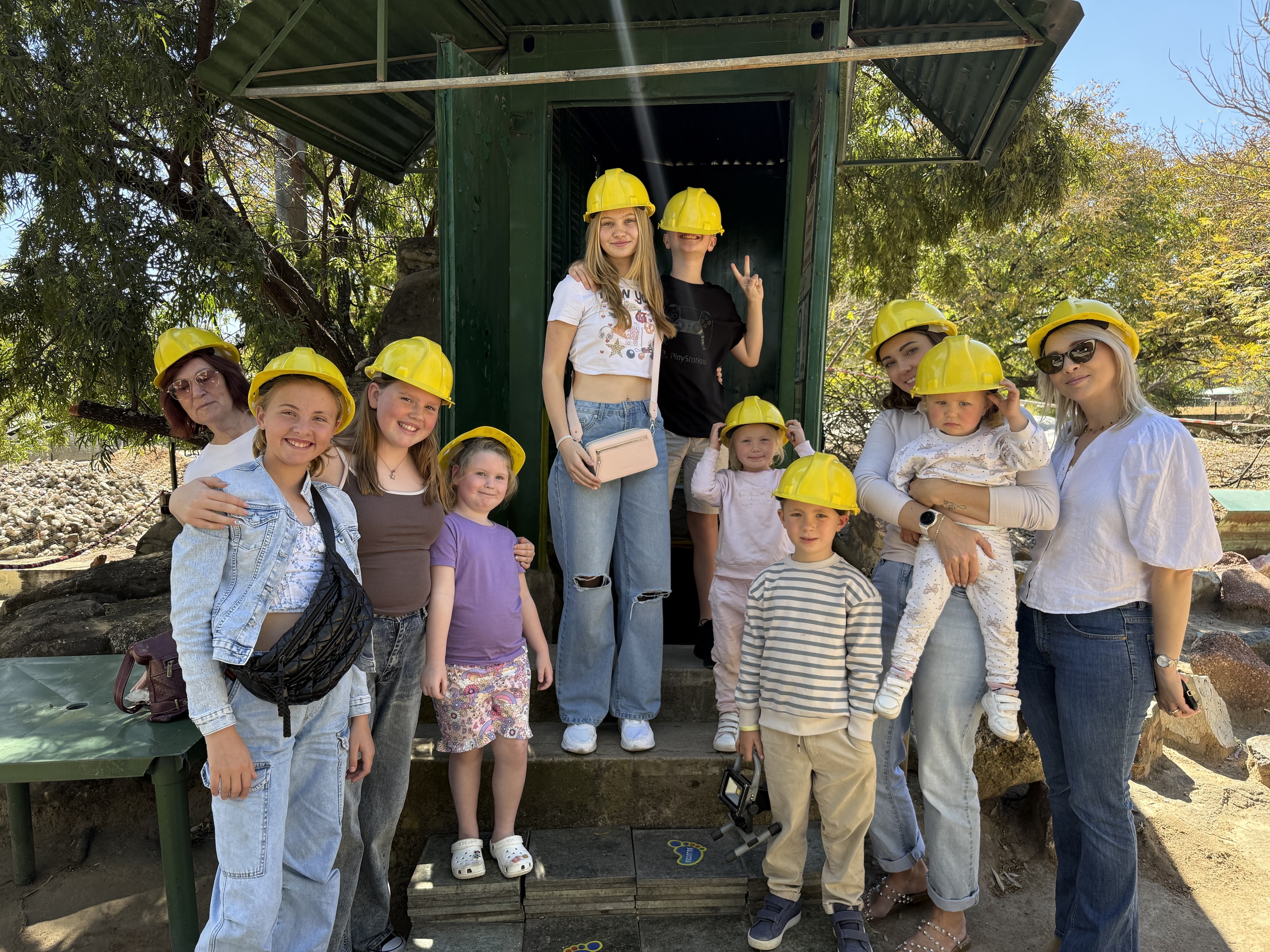 Family Activities 1 Visitors wearing yellow hard hats outside Mapatiza Mine at Gecko Jewellers