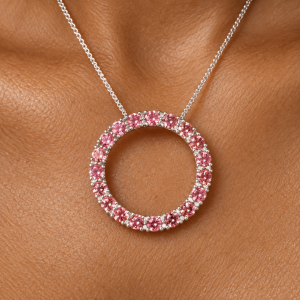 Pink tourmaline pendant on warm skin