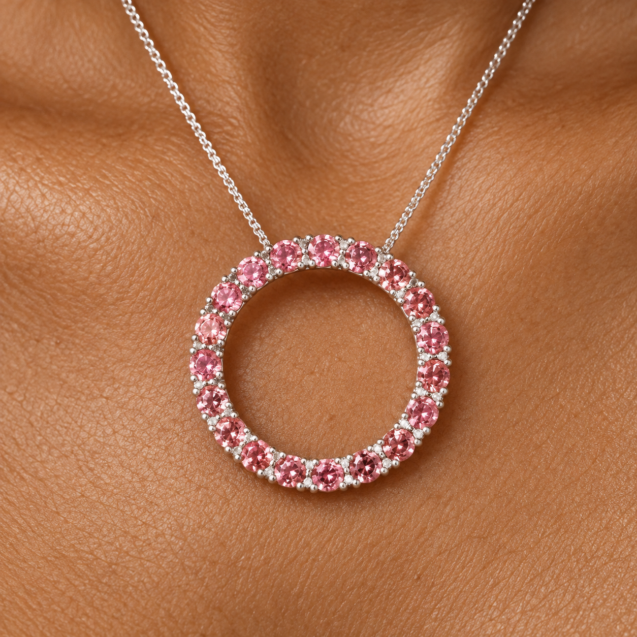 Pink tourmaline pendant on warm skin